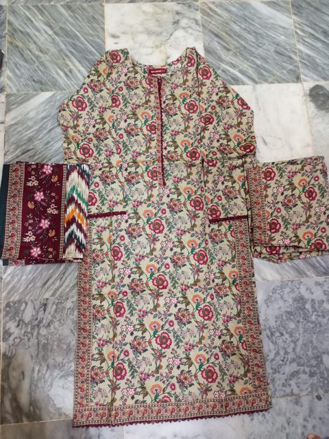 Traditional embroidered garment on a marble floor