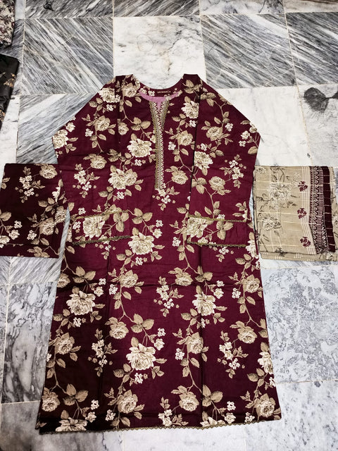 Maroon floral patterned fabric on a marble surface